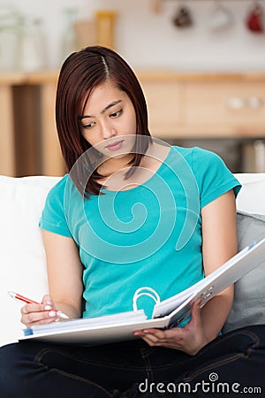 Attractive young student studying at home