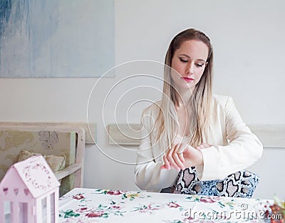 Attractive young woman in the restaurant looking at watch.