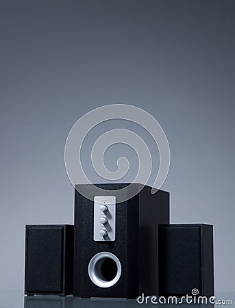 Audio speakers on gray background with reflection