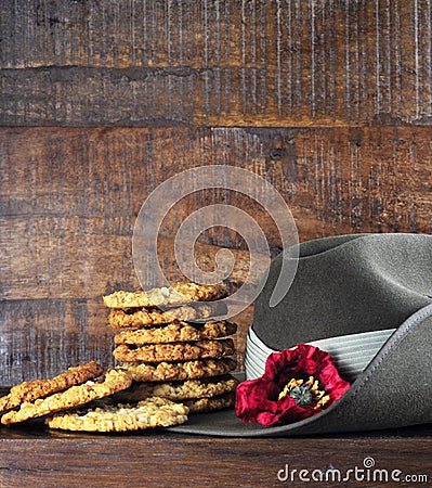 Australian army slouch hat and traditional Anzac biscuits on dark recycled wood