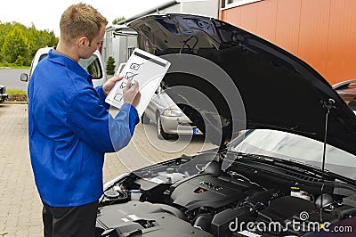 Auto mechanic checks a vehicle
