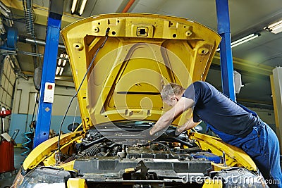 Auto mechanic repairman at work