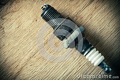 Auto service. Old spark plug as spare part of car.