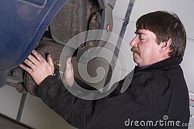 Automotive Technician Manually Pulls Rotor Checking Brakes Auto