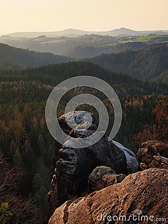 Autumn evening view over sandstone rocks to fall valley