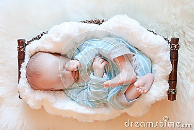 Baby Asleep in Basket on Soft White Blanket