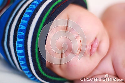 Baby in blue cap sleeping