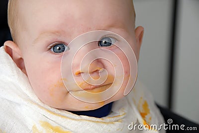 Baby boy with dirty face after a meal