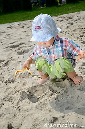 Baby boy in sandpit