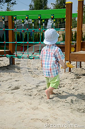 Baby boy in sandpit