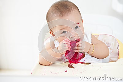 Baby eating dragon fruit