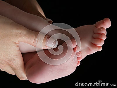 Baby feet and mom s hands