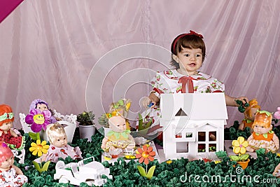 Baby girl and doll house