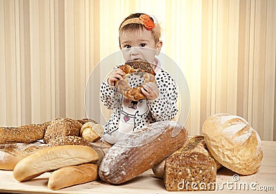 Baby girl eating bread