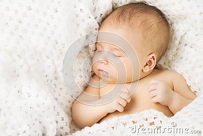 Baby newborn sleeping covered on white woollen blanket