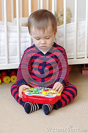 Baby plays musical toy