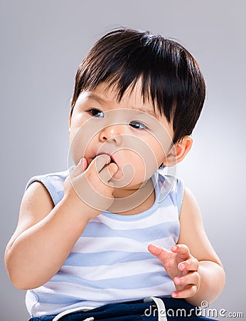 Baby sucking finger into mouth