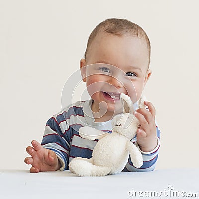 Baby with a toy rabbit