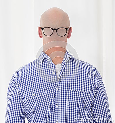 Back of a bald head with glasses