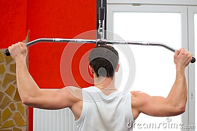 Back of a man lifting weights