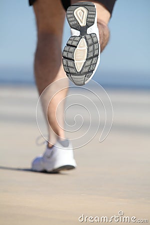 Back view of an unfocused legs of a man running