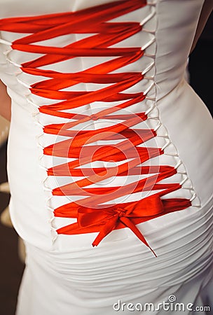 Back of wedding dress with red ribbon