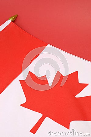 Background close up of Canadian Maple Leaf red and white flag - vertical