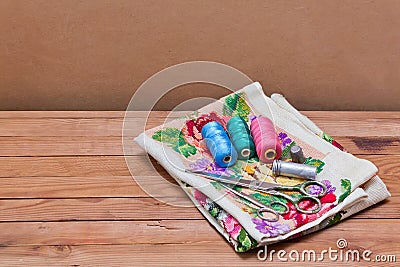 Background with sewing tools and colored thread