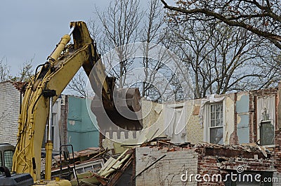 Backhoe and old home