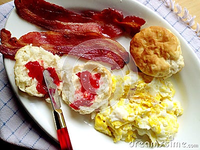 Bacon, eggs and biscuits with jam