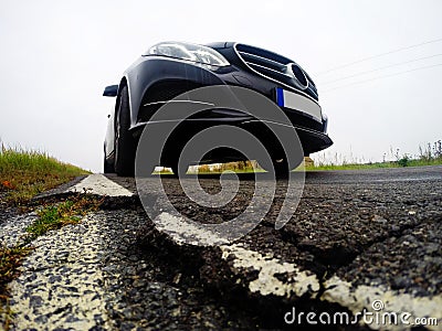 Bad, destructed road and car