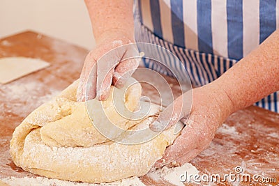 Baking biscuits -Woman kneads dough