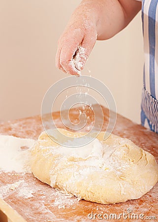 Baking biscuits -Woman kneads dough