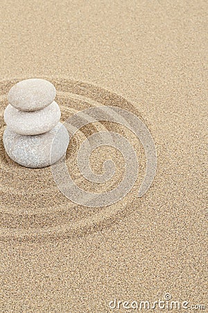 Balance zen stone in sand with circles