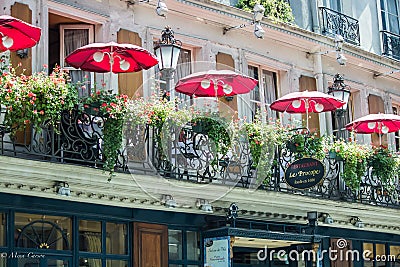 Balcony of le Procope, old restaurant in Paris, with red cafe umbrellas