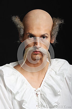 Almost bald man with long moustache in baroque dress
