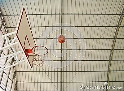 A ball going to basketball hoop