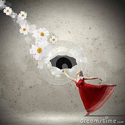Ballet dancer in flying satin dress with umbrella