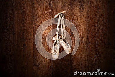 Ballet shoes hanged on a wooden wall