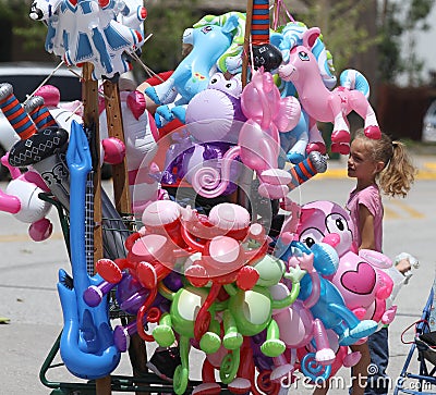 Balloon toys for sale during a parade in small town America