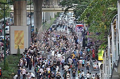 BANGKOK - JAN 2014: Unidentified Thai protesters walking along the road