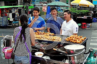 Bangkok,Thailand: Three Men Buying Food