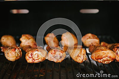 Barbecue chicken legs on the grill.