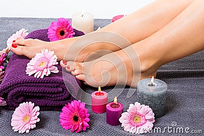 Bare feet of a woman surrounded by flowers