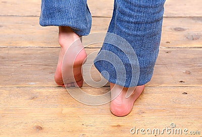 Barefoot girl walking on wooden floor