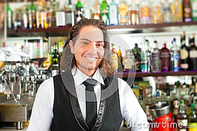 Barista or barman behind his bar