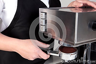 Barista using an espresso machine.