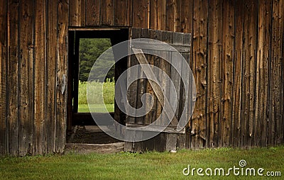Barn door open on green landscape