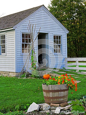 Barrel of Flowers in Front of Shed