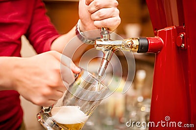 Bartender pouring beer draft in pub, bar
